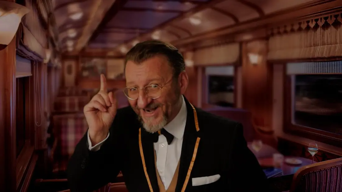 An actor in a dinner jacket and chain of office, playing a suspect
