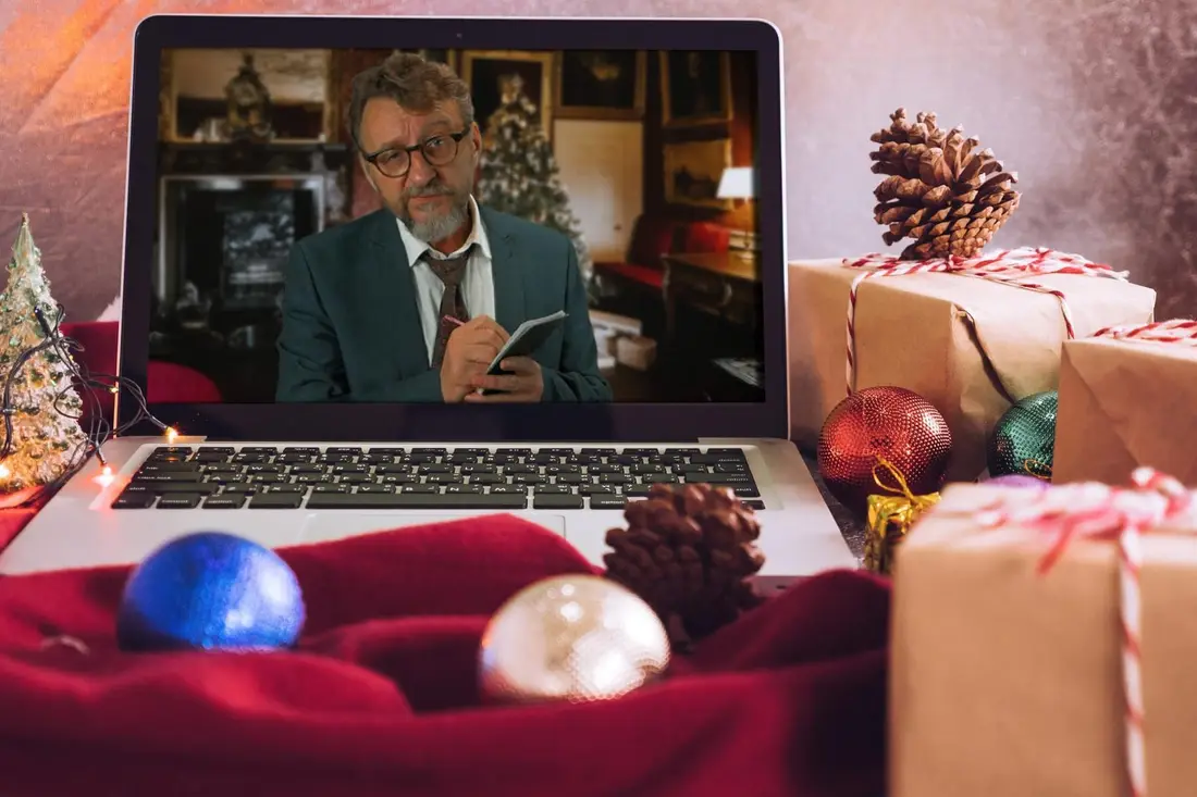 Host David on a laptop among Christmas decorations, running a virtual murder mystery