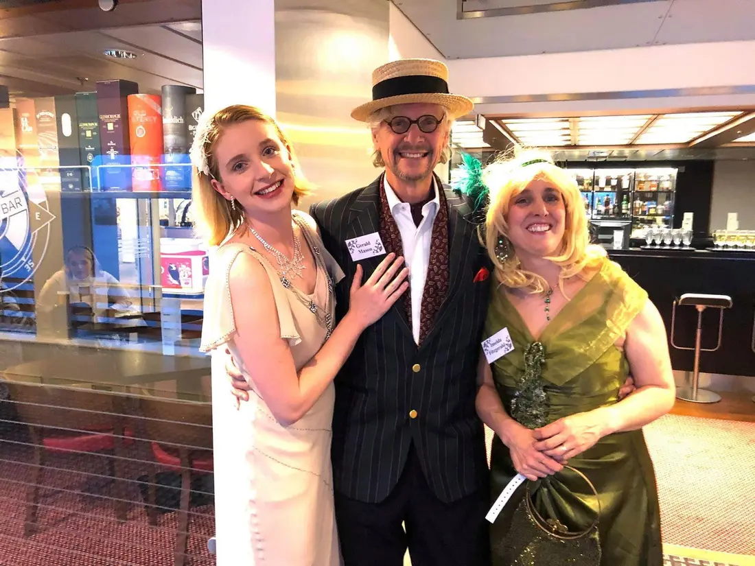 Three actors in 1920s costume posing together at a murder mystery