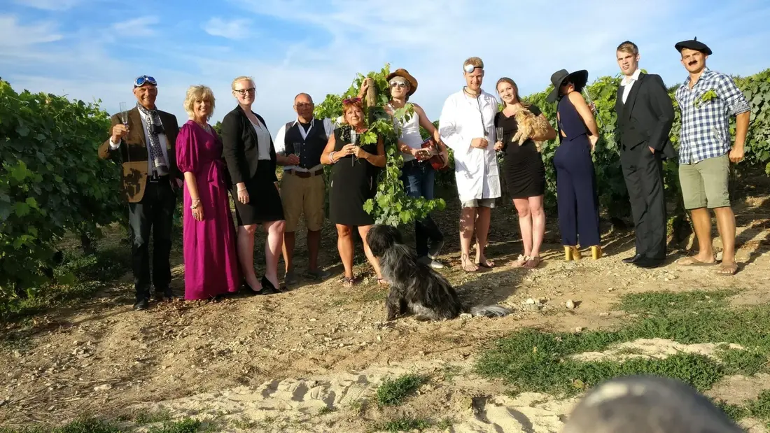 Guests in costume lined up on a hillside for a group photo