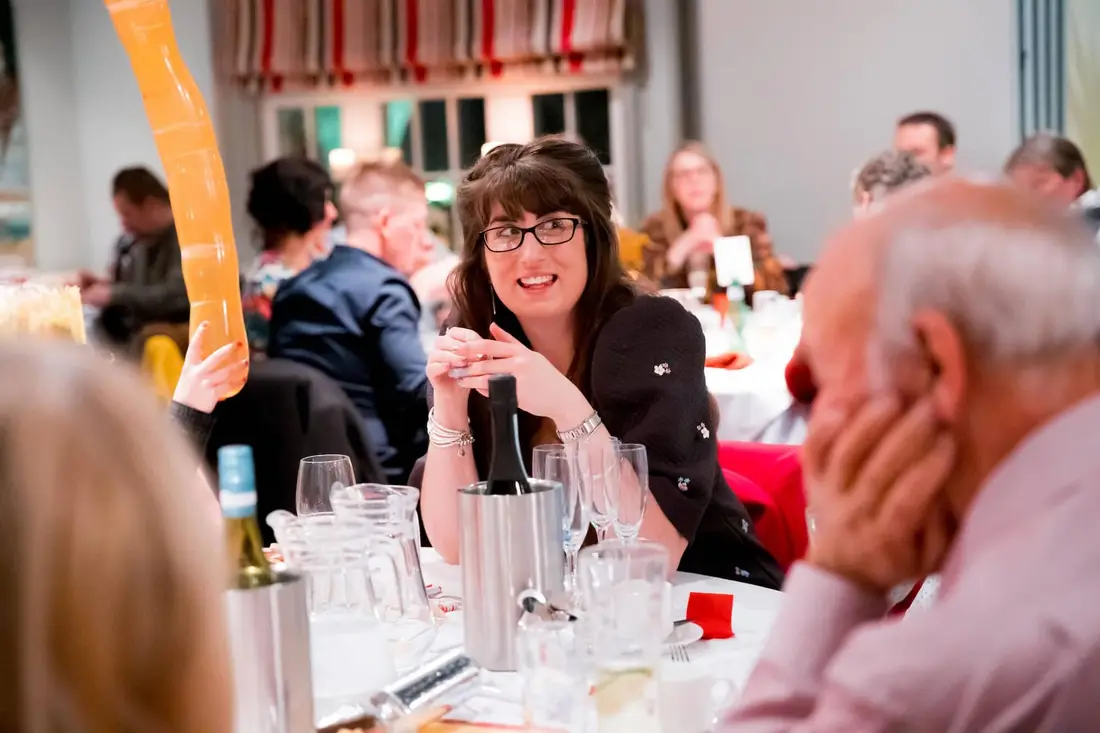 A guest laughing during a murder mystery dinner