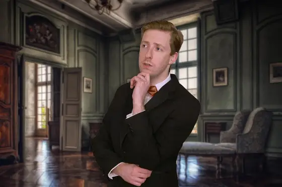 An actor in a suit, deep in thought in a panelled room