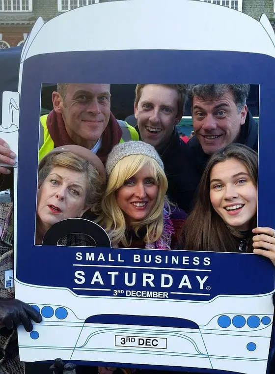 The Red Herring Games team in a Small Business Saturday bus photo frame