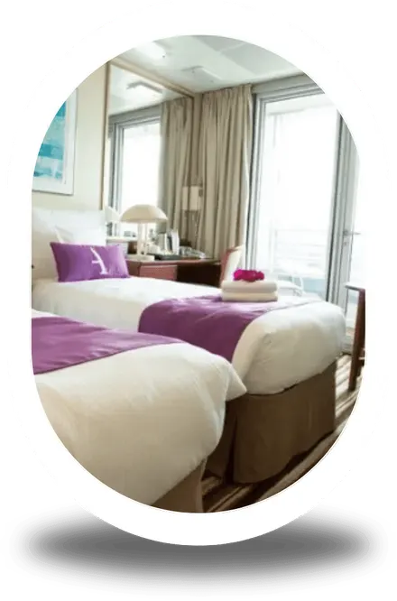 A balcony cabin with a double bed and doors onto a private balcony